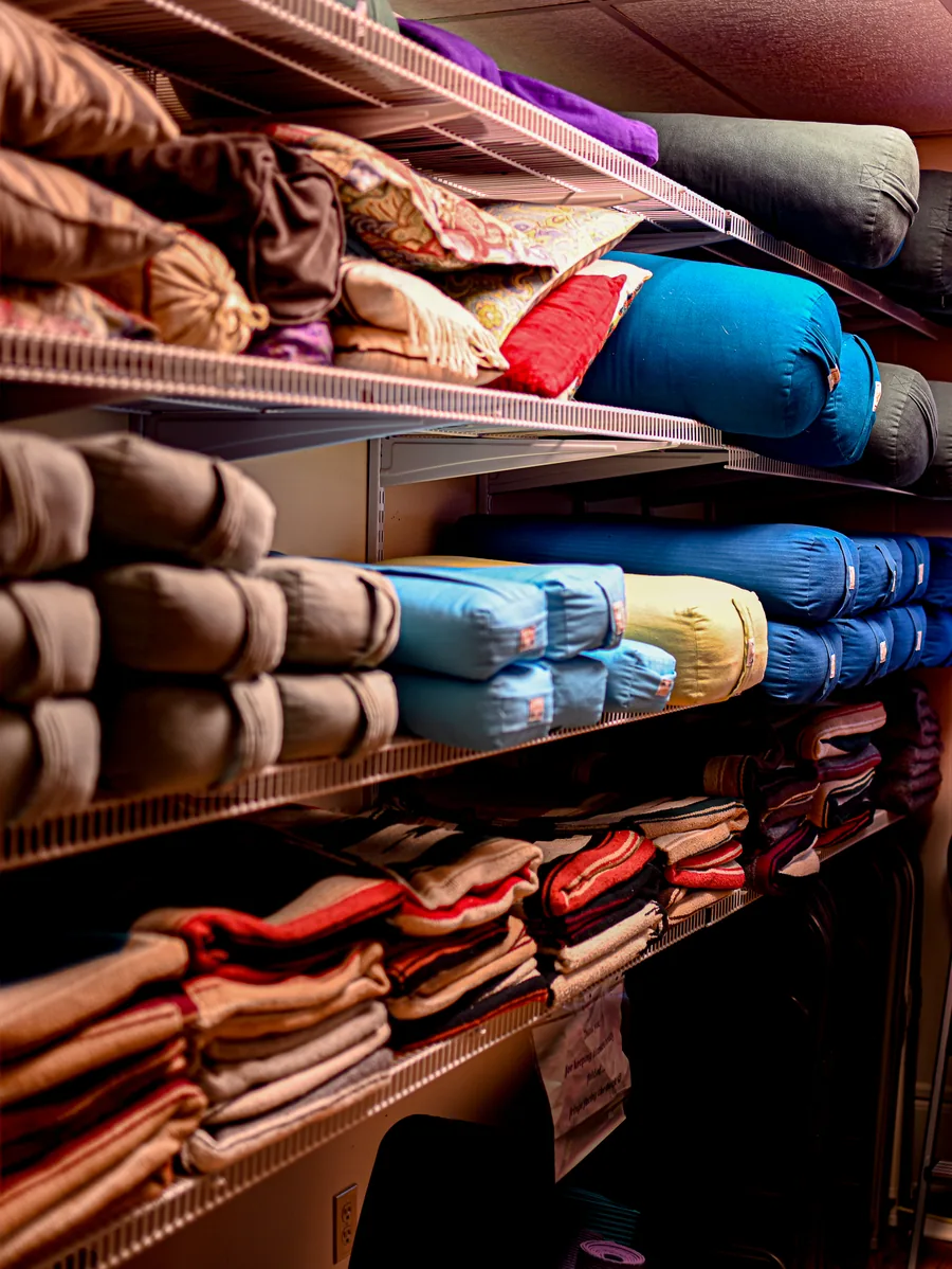 Shelves of bolsters, blankets, and props available for every class